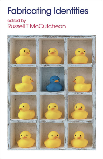 The cover of Fabricating Identities, edited by Russell T. McCutcheon. It shows a shelf with 11 yellow rubber ducks and one blue rubber duck.