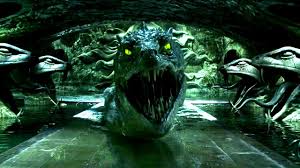 The mouth of a basilisk (giant snake) from Harry Potter flanked by two snake head statues on each side.