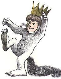 Picture of a boy in a crown and monster pajamas.