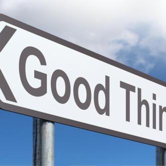 A road sign pointing to the left that says "Good Things"