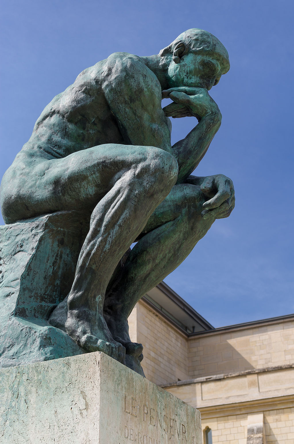 Rodin's the Thinker, a statue of a naked man sitting with his arm under his chin.