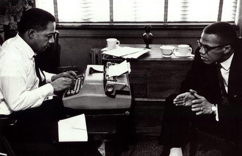 Alex Haley typing while Malcolm X speaks