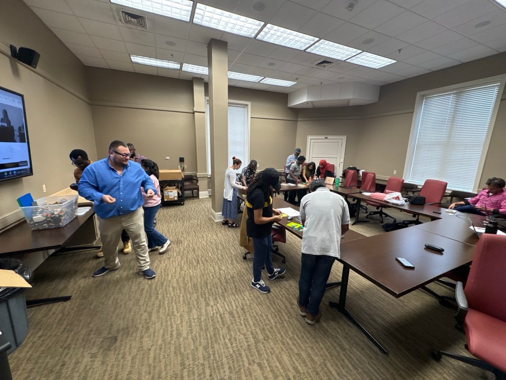 Early teachers working in groups to build with Lego.
